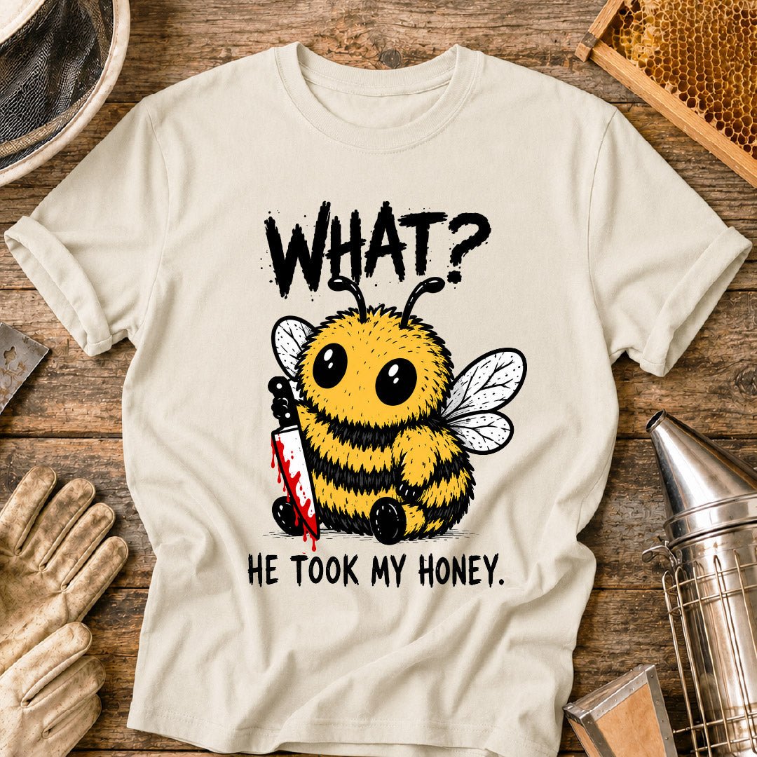 Funny beekeeper shirt design featuring a cute fluffy honey bee holding a bloody knife with the phrase “What? He Took My Honey,” a dark humor bee graphic for beekeepers and bee lovers.